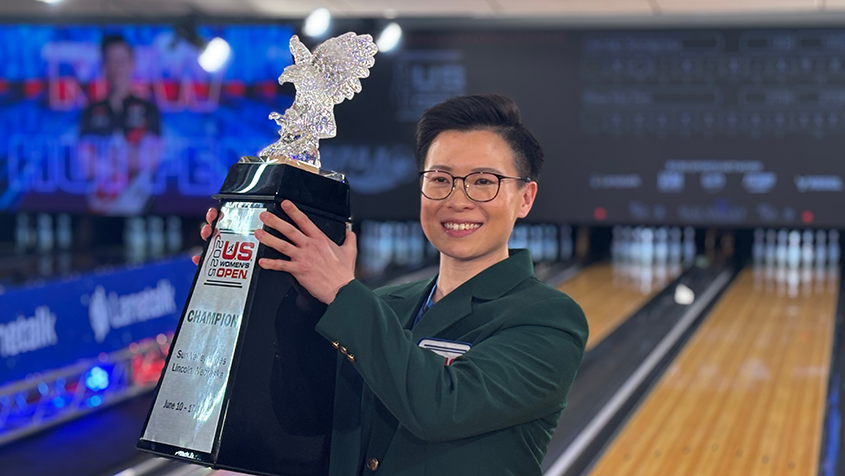 New lifts the trophy after climbing the stepladder